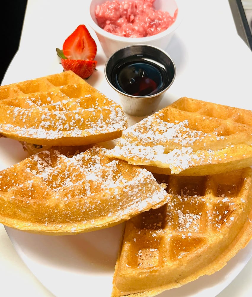 Classic Belgian waffle with strawberries and syrup