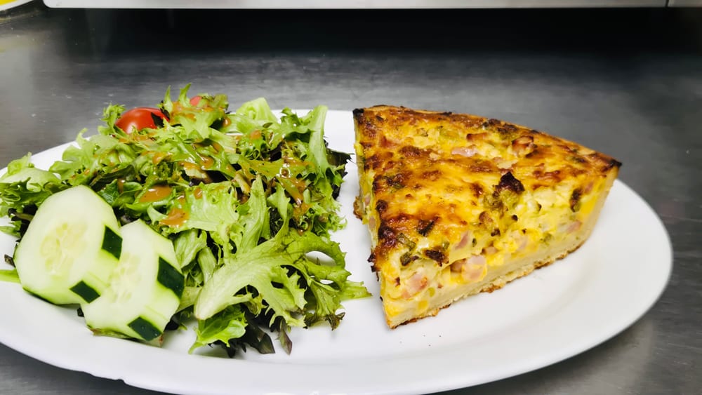 Slice of Lorraine quiche served with salad